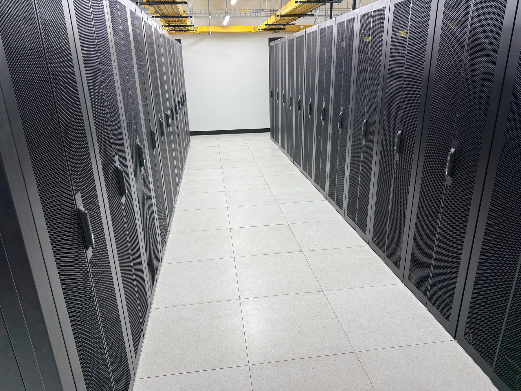 Rows of high-density data center racks in a clean server room