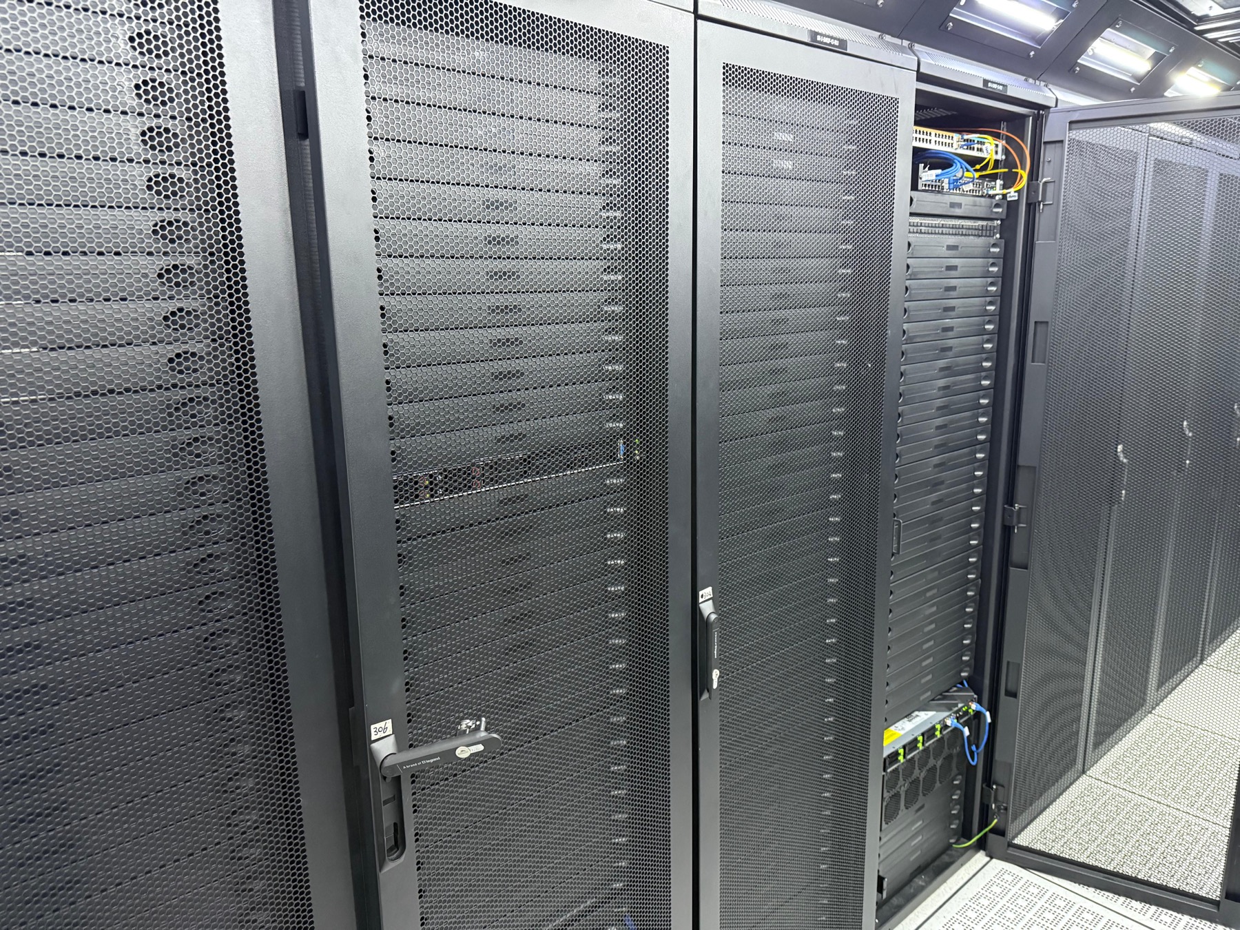 Close view of rack doors and server equipment in a data center row